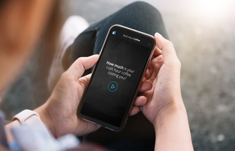 Man holding a phone with the coffee app